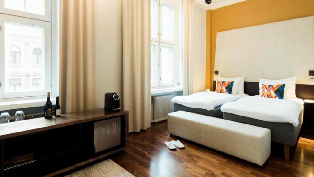 Comfortable hotel room with two single beds and modern decor.