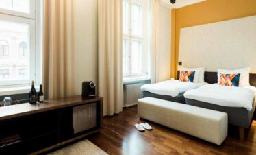 Comfortable hotel room with two single beds and modern decor.