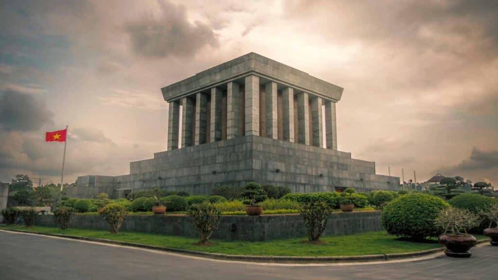 Ho Chi Minh Mausoleum in Hanoi, Vietnam, under cloudy sky.