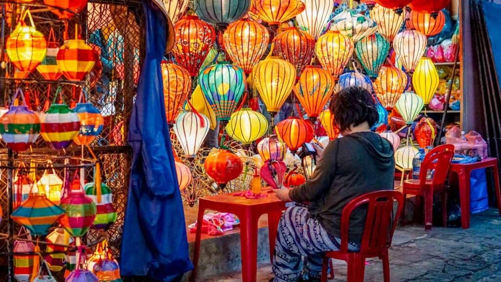 Colourful lanterns at a bustling night market stall.