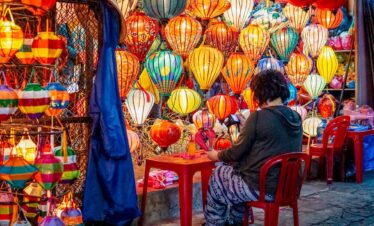 Colourful lanterns at a bustling night market stall.
