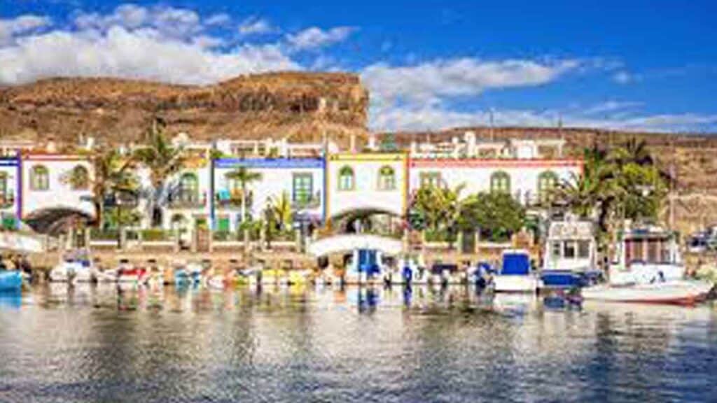 Harbour scene with vibrant buildings and boats in a tropical setting.