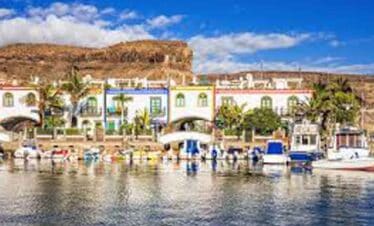 Harbour scene with vibrant buildings and boats in a tropical setting.