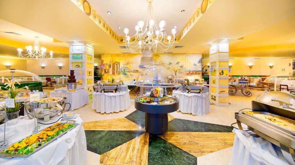 Buffet breakfast with a variety of fresh foods and beverages in a bright, elegant hotel dining area.