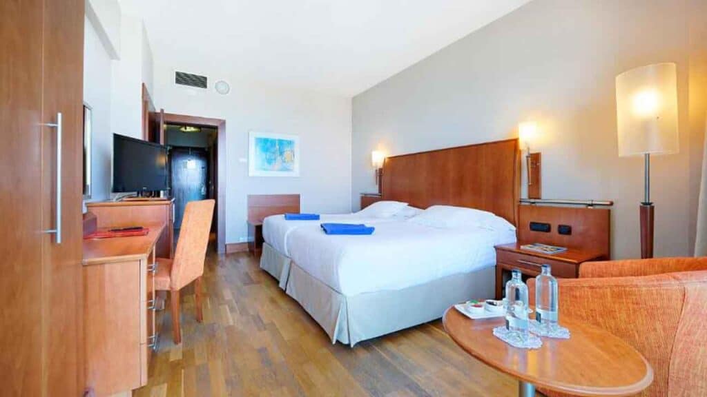 Spacious hotel room with a large bed, modern decor, and amenities for a relaxing stay. Perfect for t.