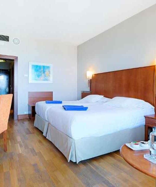 Spacious hotel room with a large bed, modern decor, and amenities for a relaxing stay. Perfect for t.