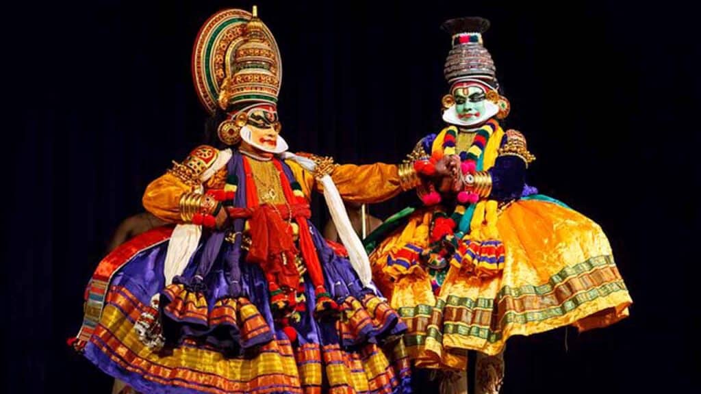 Kathakali dancers in colourful costumes perform a classical Indian dance.