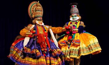 Kathakali dancers in colourful costumes perform a classical Indian dance.