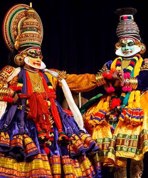 Kathakali dancers in colourful costumes perform a classical Indian dance.