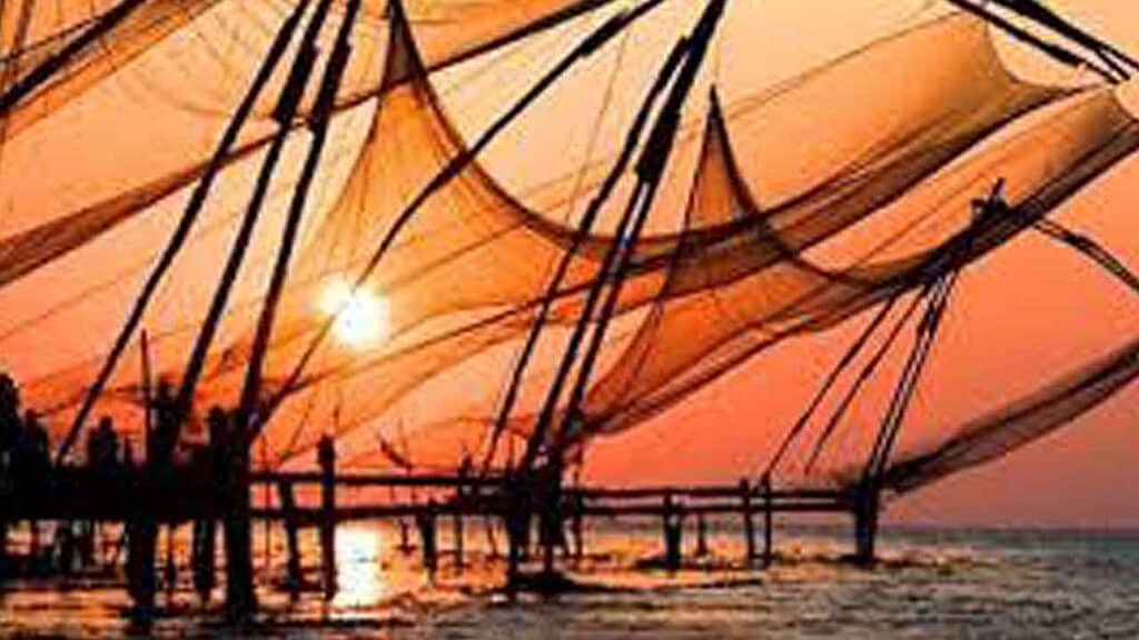 Sunset casting warm orange hues over fishing boats on the water.