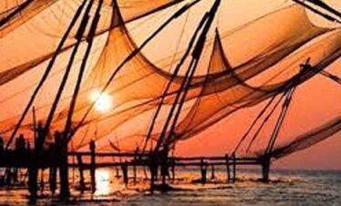 Sunset casting warm orange hues over fishing boats on the water.