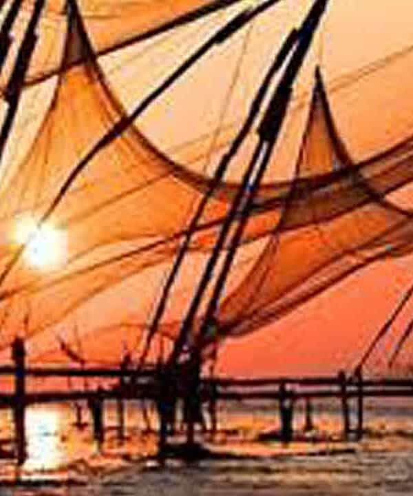 Sunset casting warm orange hues over fishing boats on the water.