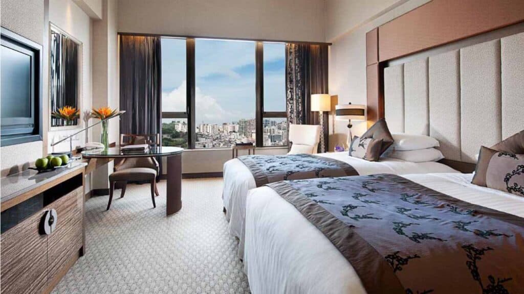 Modern hotel room with city skyline view in Taiwan, Macau, and Hong Kong.