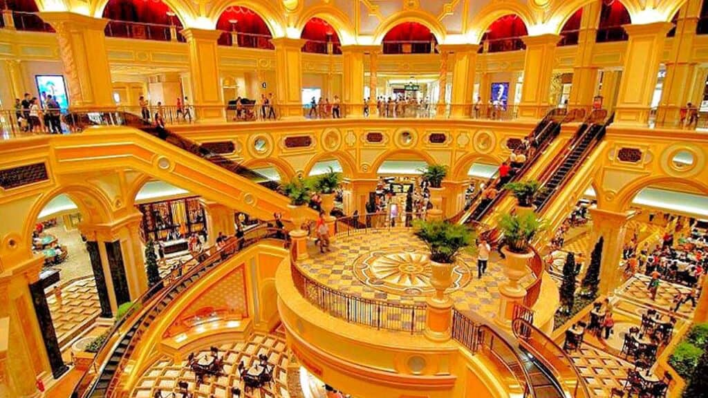 Elegant interior of Macau's grand casino with ornate architecture and vibrant lighting.