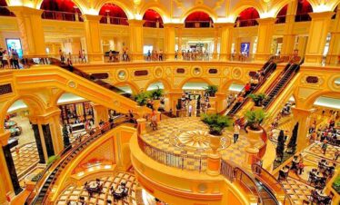 Elegant interior of Macau's grand casino with ornate architecture and vibrant lighting.