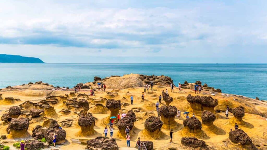 Scenic coastal rocks and visitors at a seaside location in Taiwan, Macau, or Hong Kong.