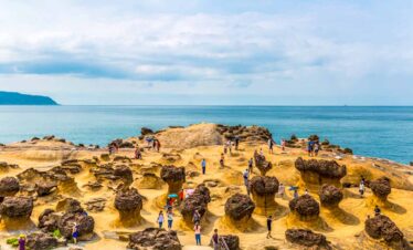 Scenic coastal rocks and visitors at a seaside location in Taiwan, Macau, or Hong Kong.