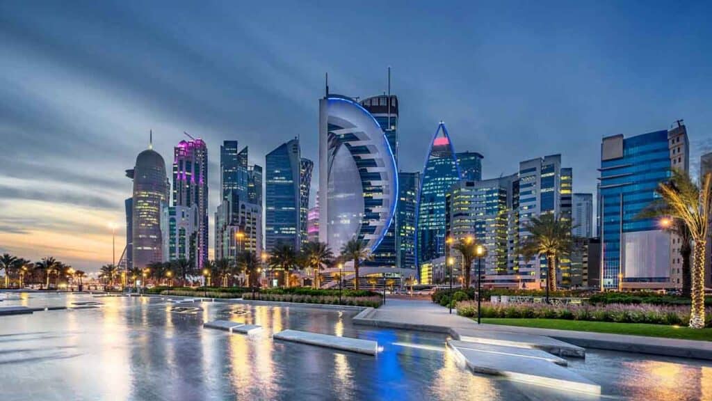 Dubai skyline with iconic buildings and waterfront view at sunset.