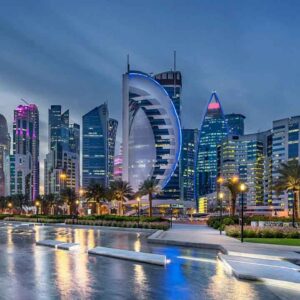 Dubai skyline with iconic buildings and waterfront view at sunset.