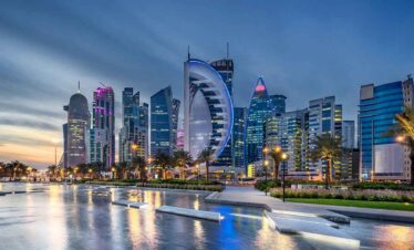 Dubai skyline with iconic buildings and waterfront view at sunset.
