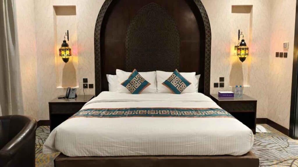 Luxurious hotel bedroom with elegant decor and plush bedding.