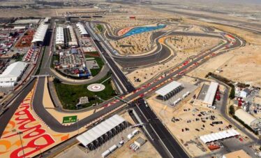 Race track at a desert racing circuit with sharp turns and spectator areas.