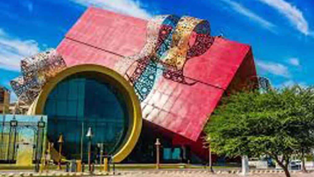 Modern colourful building with circular entrance and unique architecture.