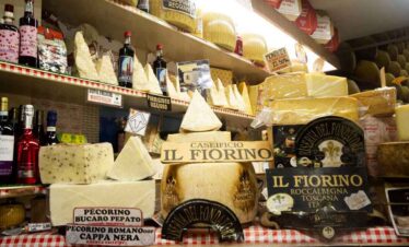 Assorted Italian cheeses including Pecorino and Parmesan on display.