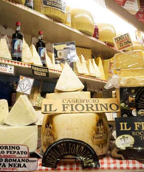 Assorted Italian cheeses including Pecorino and Parmesan on display.