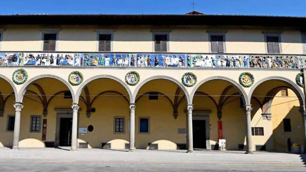 Historic building with arches and decorative balcony railings.