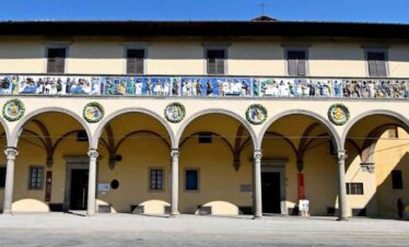 Historic building with arches and decorative balcony railings.