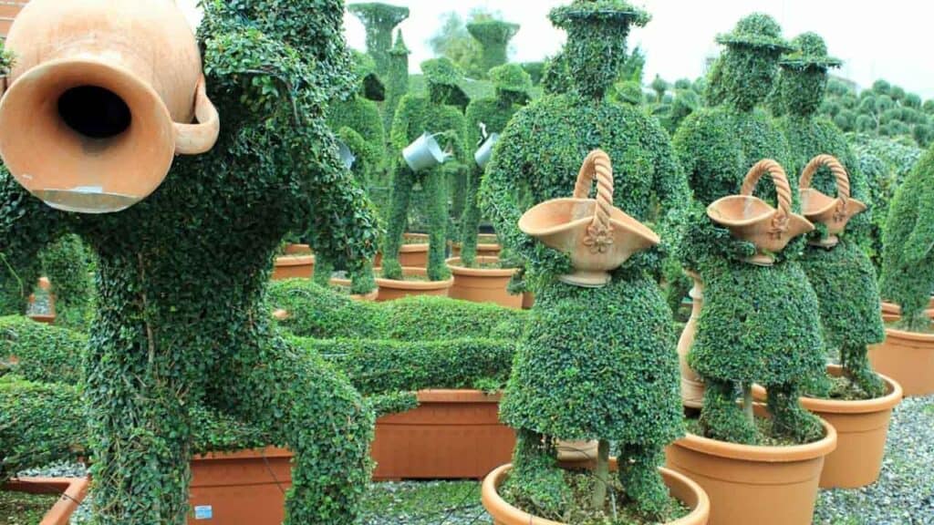 Creative topiary garden with animal-shaped bushes and pots.