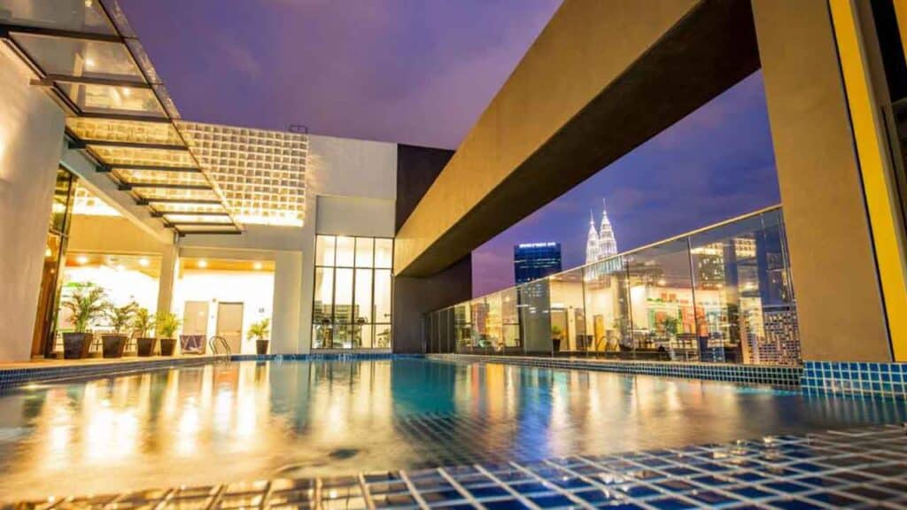 Rooftop pool overlooking city skyline with Empire State Building in the background.