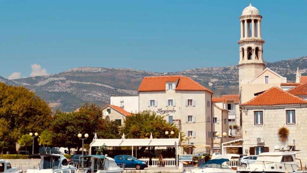 Beautiful coastal town with historic buildings and a church tower, perfect for holiday adventures.