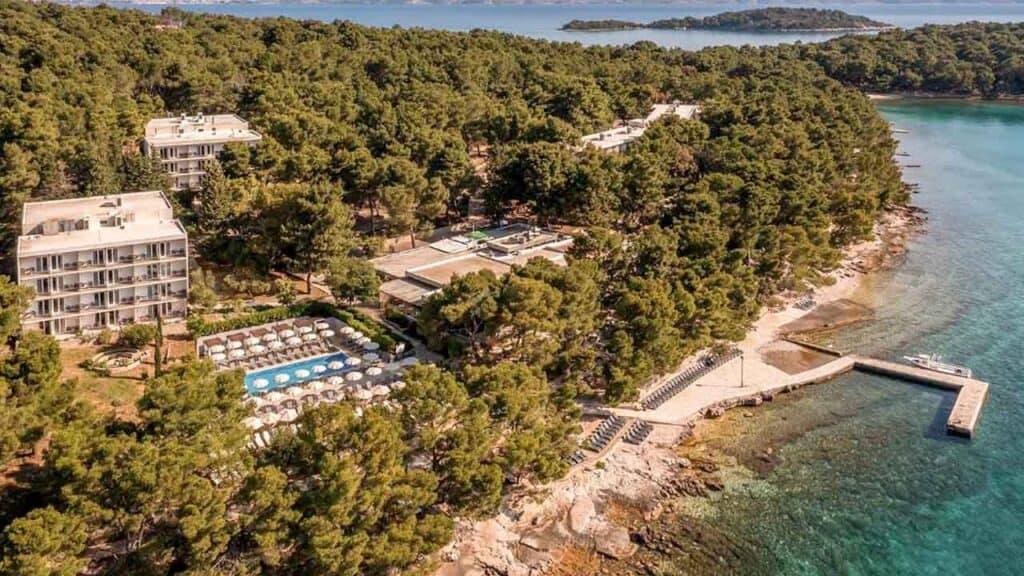 Luxury seaside resort with lush greenery and private beach access.