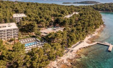 Luxury seaside resort with lush greenery and private beach access.
