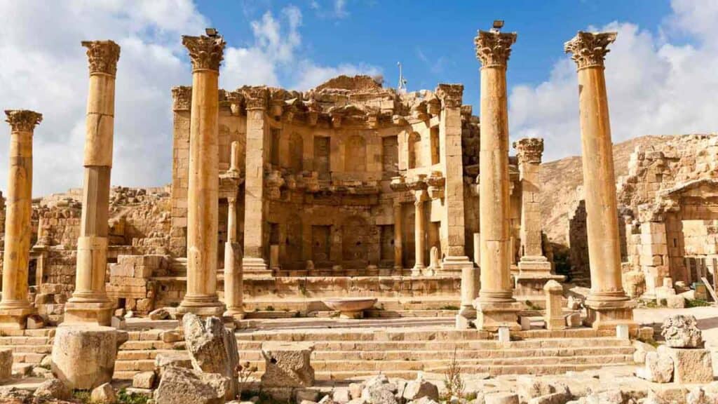 Roman theatre ruins in Jerash, Jordan, with tall columns and stone steps.