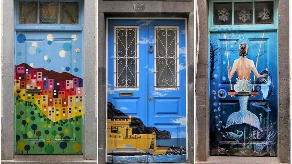 Vibrant mural on city door featuring colourful buildings and ocean-themed art.