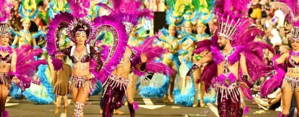 Colourful carnival dancers in elaborate costumes and feathers.