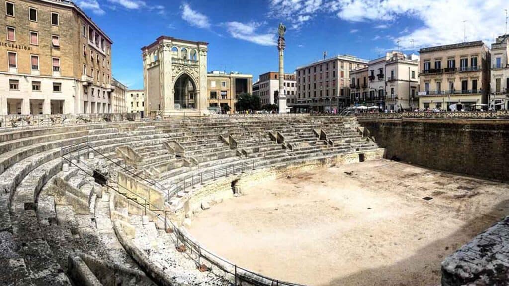 Ancient Roman amphitheatre ruins located in the heart of the city, showcasing historical architectur.