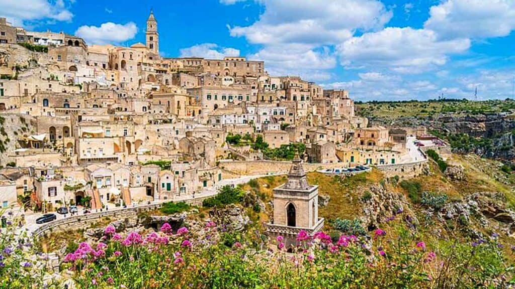 Colourful hillside town with historic buildings and panoramic views of the landscape.