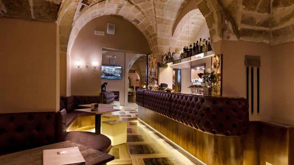 Indoor bar with stone arches and warm lighting at Travel Buddies Holidays.