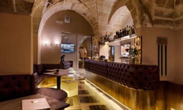 Indoor bar with stone arches and warm lighting at Travel Buddies Holidays.