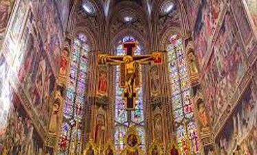Stunning Gothic cathedral interior with colourful stained glass windows and intricate architecture.