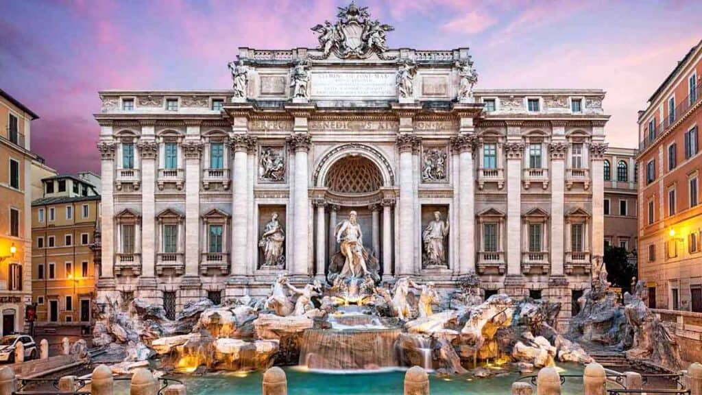 Iconic Trevi Fountain in Rome at sunset with historic architecture.