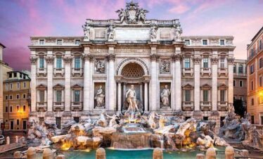 Iconic Trevi Fountain in Rome at sunset with historic architecture.