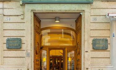 H.M. Museum entrance with wooden doors and potted plants.