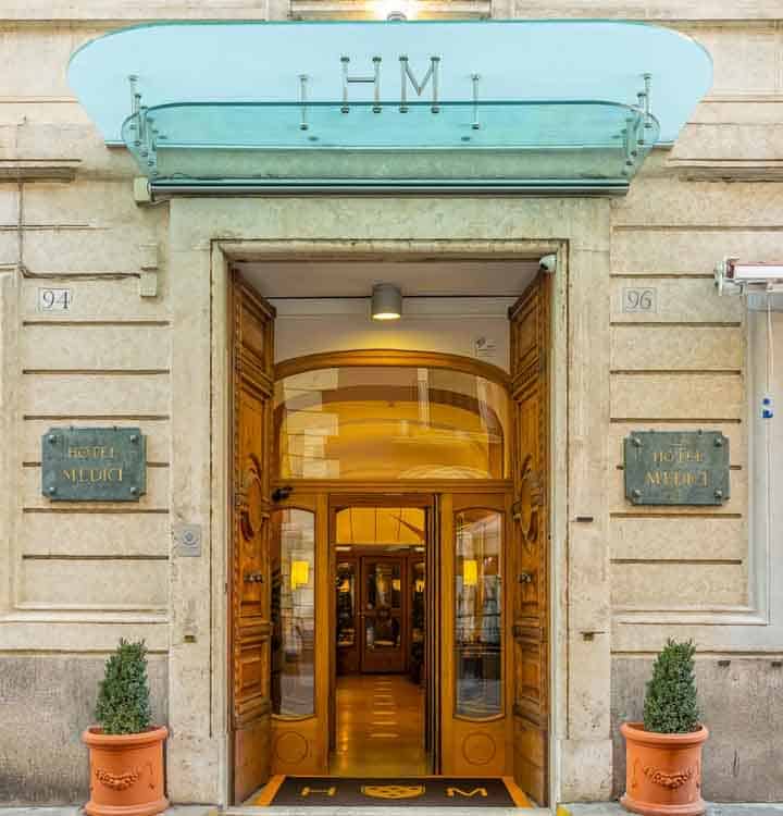 H.M. Museum entrance with wooden doors and potted plants.