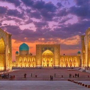 Blue Mosque with illuminated minarets during sunset.