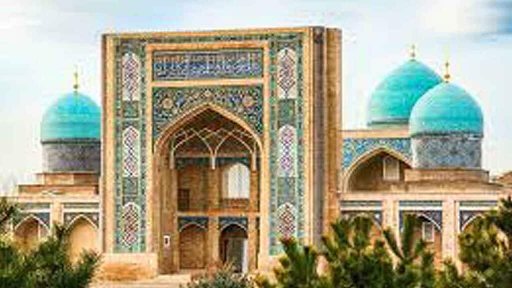 Beautiful Islamic building with turquoise domes and intricate tile work.